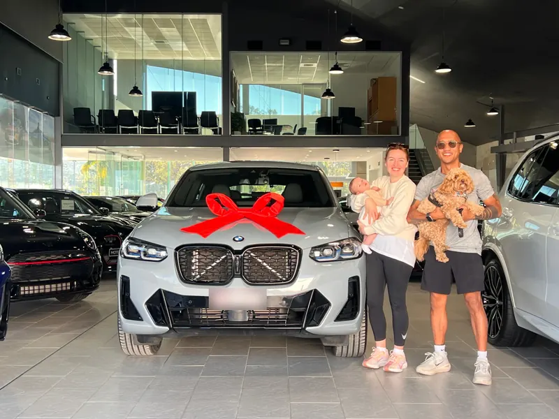 Family collecting their new BMW SUV, financed through Simple Loans