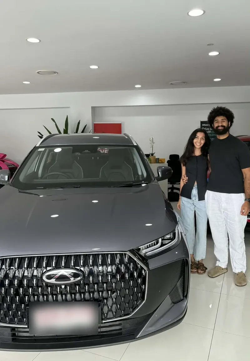 Couple collecting their new Chery SUV at the dealership, financed through Simple Loans