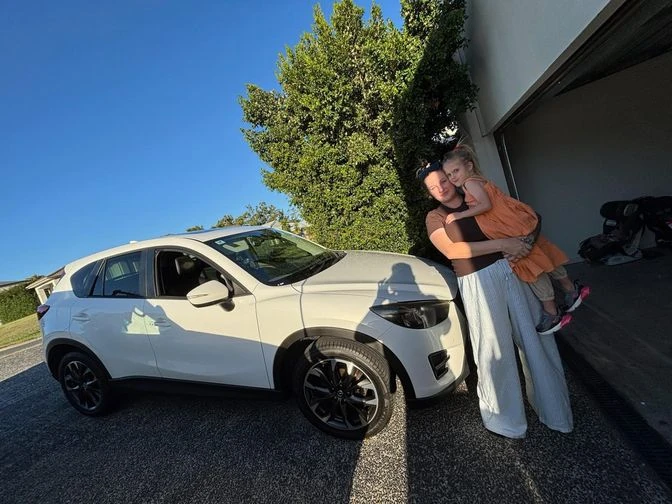 Mother and daughter with the family SUV financed through Simple Loans
